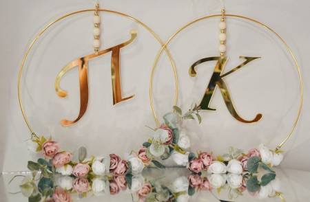 Room decoration with gold monograms and decorated with flowers